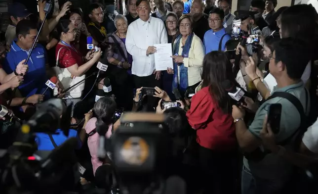 Former Senator Leila de Lima and Akbayan Partylist representative Perci Cendana show a copy of an impeachment complaint which they prepared to file against Philippine Vice President Sara Duterte as they wait for the secretary general to receive it at the House of Representatives in Quezon City, Philippines on Monday Dec. 2, 2024. (AP Photo/Aaron Favila)