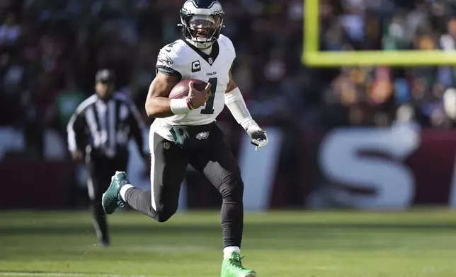 Philadelphia Eagles quarterback Jalen Hurts (1) running with the ball during the first half of an NFL football game against the Washington Commanders, Sunday, Dec. 22, 2024, in Landover, Md. (AP Photo/Stephanie Scarbrough)