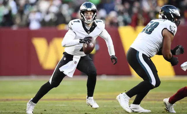 Philadelphia Eagles quarterback Kenny Pickett (7) looking downfield as he runs with the ball during the second half of an NFL football game against the Washington Commanders, Sunday, Dec. 22, 2024, in Landover, Md. (AP Photo/Nick Wass)