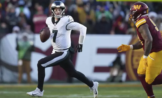 Philadelphia Eagles quarterback Kenny Pickett (7) scrambles out of the pocket during the first half of an NFL football game against the Washington Commanders, Sunday, Dec. 22, 2024, in Landover, Md. (AP Photo/Stephanie Scarbrough)