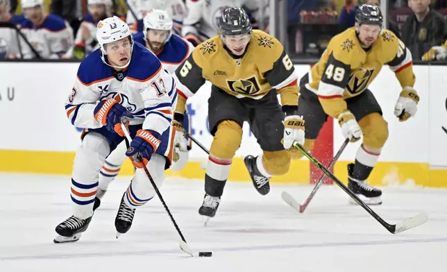 Edmonton Oilers center Mattias Janmark skates with the puck against the Vegas Golden Knights during the first period of an NHL hockey game, Tuesday, Dec. 3, 2024, in Las Vegas. (AP Photo/David Becker)