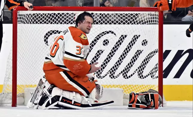 Anaheim Ducks goaltender John Gibson (36) reacts after an apparent injury to his face during the first period of an NHL hockey game against the Vegas Golden Knights Monday, Dec. 23, 2024, in Las Vegas. (AP Photo/David Becker)