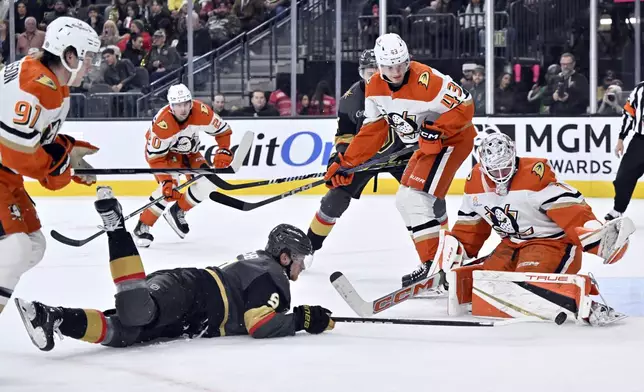 Vegas Golden Knights center Jack Eichel (9) shoots against Anaheim Ducks goaltender Lukas Dostal (1) during the second period of an NHL hockey game Monday, Dec. 23, 2024, in Las Vegas. (AP Photo/David Becker)