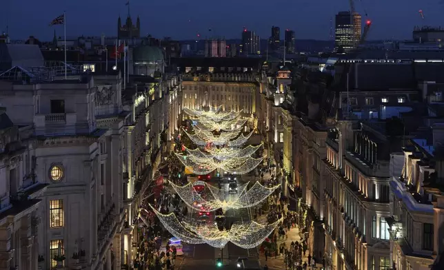 Christmas lights are displayed on Regent Street, in London, Wednesday, Nov. 20, 2024. (AP Photo/Kin Cheung)