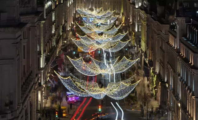 Christmas lights are displayed on Regent Street, in London, Wednesday, Nov. 20, 2024. (AP Photo/Kin Cheung)
