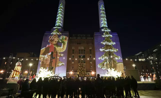 Images of cartoon characters Wallace &amp; Gromit created by British animation studio Aardman, are projected at the Battersea Power Station to celebrate the Christmas season, in London, Friday, Nov. 29 2024. (AP Photo/Kin Cheung)