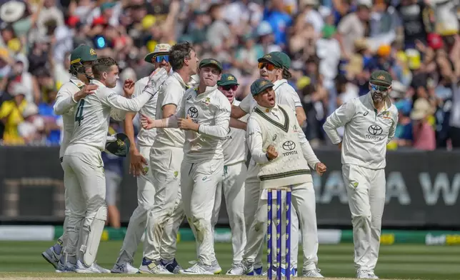 Australian players celebrates the wicket of India's Yashasvi Jaiswal during play on the last day of the fourth cricket test between Australia and India at the Melbourne Cricket Ground, Melbourne, Australia, Monday, Dec. 30, 2024. (AP Photo/Asanka Brendon Ratnayake)