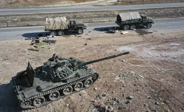 Abandoned Syrian army armoured vehicles sit on a road as opposition insurgents control the outskirts of Hama, Syria, Tuesday Dec. 3, 2024.(AP Photo/Ghaith Alsayed)