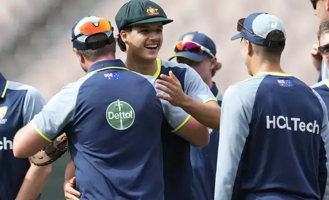 Australia's Sam Konstas, centre, is congratulated by teammates after he was presented with his baggy green cap ahead of play on the first day of the fourth cricket test between Australia and India at the Melbourne Cricket Ground, Melbourne, Australia, Thursday, Dec. 26, 2024. (AP Photo/Asanka Brendon Ratnayake)