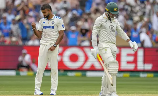 India's Akash Deep, left, celebrates the wicket of Australia's Alex Carey, right, during play on the first day of the fourth cricket test between Australia and India at the Melbourne Cricket Ground, Melbourne, Australia, Thursday, Dec. 26, 2024. (AP Photo/Asanka Brendon Ratnayake)