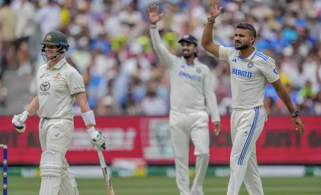 India's Akash Deep, right, appeals unsuccessfully for an LBW against Australia's Steve Smith, left, during play on the first day of the fourth cricket test between Australia and India at the Melbourne Cricket Ground, Melbourne, Australia, Thursday, Dec. 26, 2024. (AP Photo/Asanka Brendon Ratnayake)