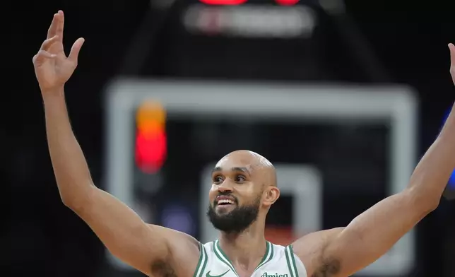 Boston Celtics guard Derrick White celebrates after his team scored a 3-point basket in the first half of an NBA basketball game against the Minnesota Timberwolves, Sunday, Nov. 24, 2024, in Boston. (AP Photo/Steven Senne)