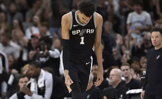 San Antonio Spurs forward Victor Wembanyama (1) celebrates after a 3-point basket during the second half of an NBA basketball game against the Golden State Warriors, Saturday, Nov. 23, 2024, in San Antonio. (AP Photo/Darren Abate)