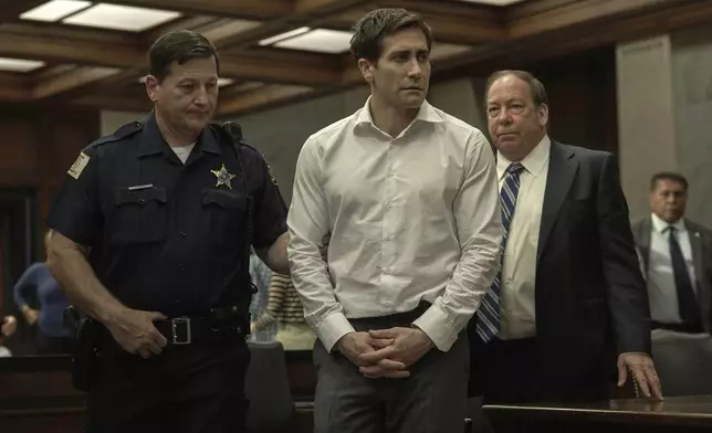 This image released by Apple TV+ shows Jake Gyllenhaal, center, and Bill Camp, right, in a scene from the series "Presumed Innocent." (Apple TV+ via AP)