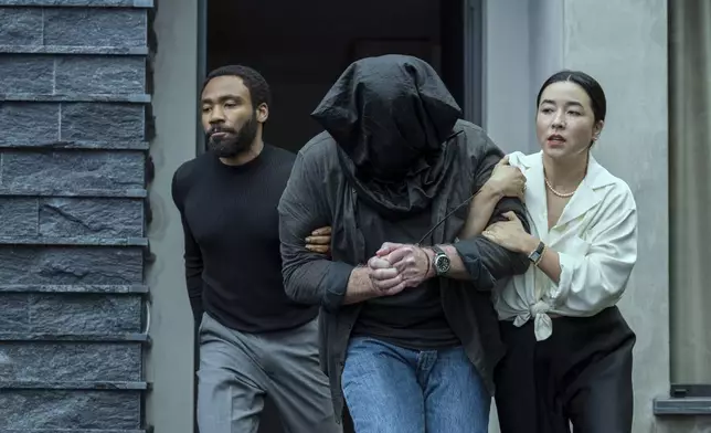 This image released by Prime Video shows Donald Glover, left, and Maya Erskine in a scene from "Mr. and Mrs. Smith." (David Lee/Prime Video via AP)