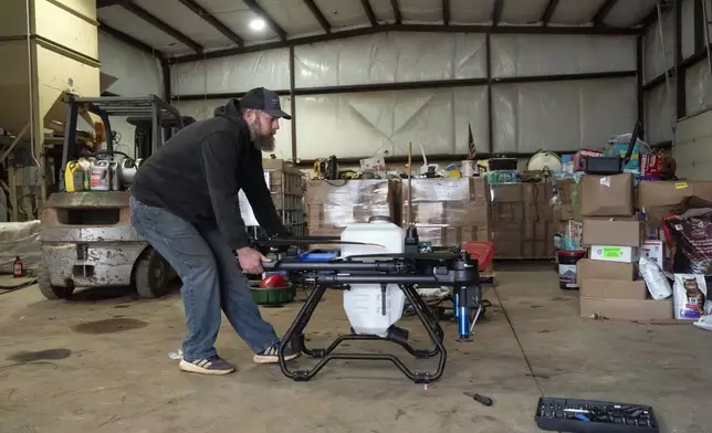 Russell Hedrick pulls out an EA Vision drone on his farm, Tuesday, Dec. 17, 2024, in Hickory, N.C. (AP Photo/Allison Joyce)