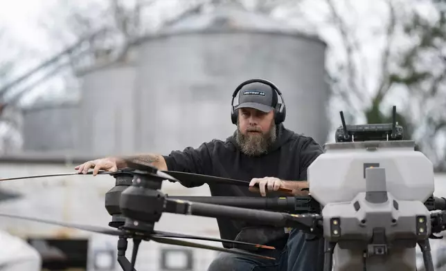 Russell Hedrick prepares a DJI drone to put crop cover on his farm, Tuesday, Dec. 17, 2024, in Hickory, N.C. (AP Photo/Allison Joyce)