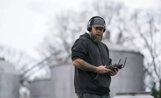 Russell Hedrick uses a DJI drone to put crop cover on his farm, Tuesday, Dec. 17, 2024, in Hickory, N.C. (AP Photo/Allison Joyce)