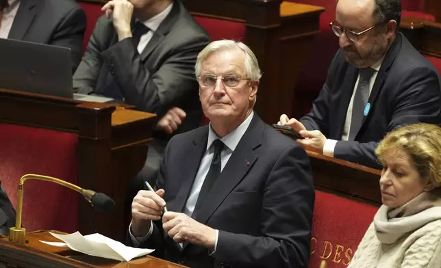 French Prime Minister Michel Barnier sits at the National Assembly while France's minority government may be on its last legs as opposition lawmakers moved this week toward a no-confidence vote, Monday, Dec. 2, 2024 in Paris. (AP Photo/Michel Euler)