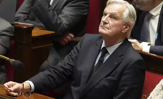 French Prime Minister Michel Barnier attends a debate at the National Assembly while France's minority government may be on its last legs as opposition lawmakers moved this week toward a no-confidence vote, Monday, Dec. 2, 2024 in Paris. (AP Photo/Michel Euler)