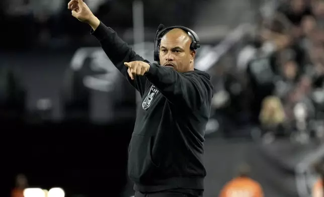 Las Vegas Raiders head coach Antonio Pierce makes a call during the second half of an NFL football game against the Atlanta Falcons, Monday, Dec. 16, 2024, in Las Vegas. (AP Photo/Rick Scuteri)