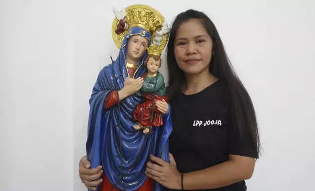 Filipino death-row drug convict Mary Jane Veloso poses for a photo with a Mother Mary statue during a Christmas event at the Yogyakarta Women's Prison in Gunung Kidul, Indonesia, Tuesday, Dec. 10, 2024. (AP Photo/Slamet Riyadi)