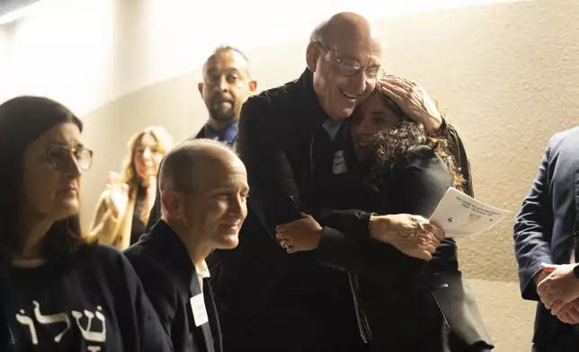 Benjamin Warren hugs Harris County Judge Lina Hidalgo after she spoke during a Chicanukah event at Holocaust Museum Houston on Thursday, December 19, 2024, in Houston. (AP Photo/Annie Mulligan)