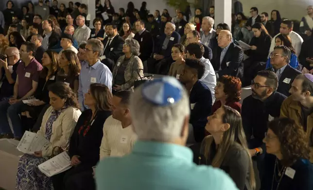 Guests listen to speakers during a Chicanukah event at Holocaust Museum Houston on Thursday, December 19, 2024, in Houston. (AP Photo/Annie Mulligan)