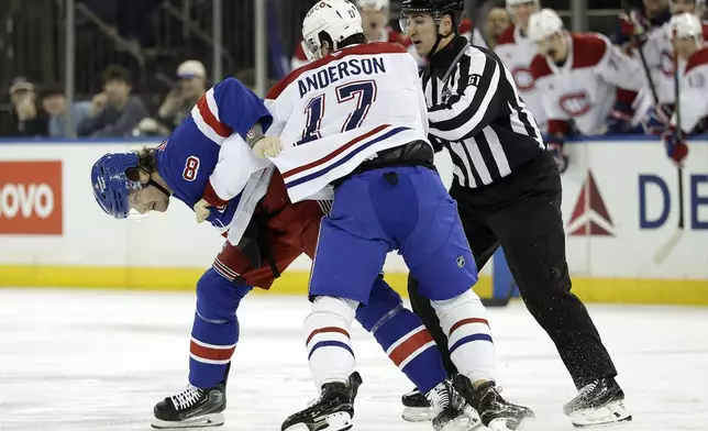 Montreal Canadiens right wing Josh Anderson (17) fights New York Rangers defenseman Jacob Trouba in the first period of an NHL hockey game Saturday, Nov. 30, 2024, in New York. (AP Photo/Adam Hunger)