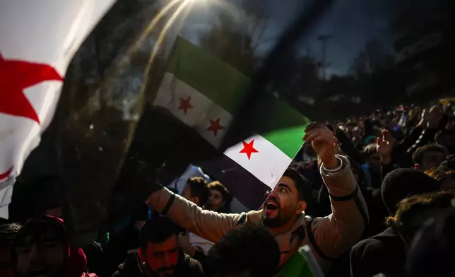 People gather to celebrate the Syrian government's fall, in Istanbul, Turkey, Sunday, Dec. 8, 2024. (AP Photo/Emrah Gurel)