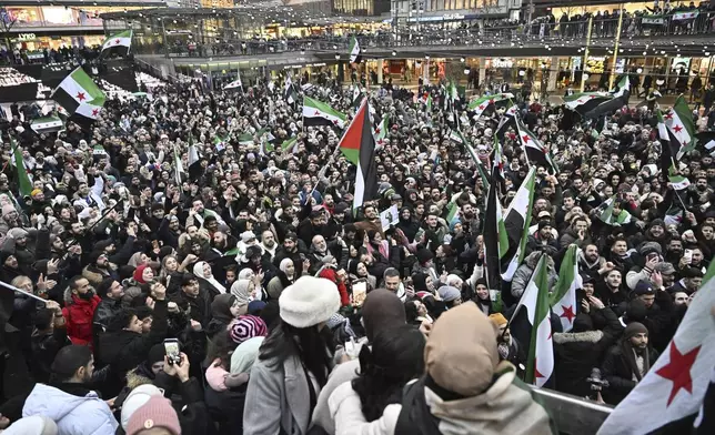 Syrians celebrate the fall of the Assad regime in Syria at a demonstration in Stockholm, Sweden, Sunday, Dec. 8, 2024. (Jonas Ekstroemer/TT News Agency via AP)