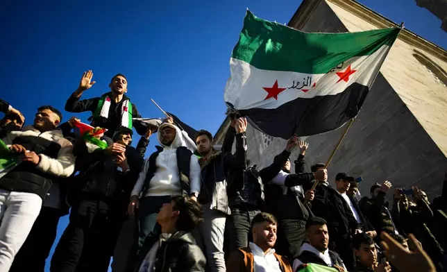 People gather to celebrate the Syrian government fall at Faith mosque in Istanbul, Turkey, Sunday, Dec. 8, 2024. (AP Photo/Emrah Gurel)