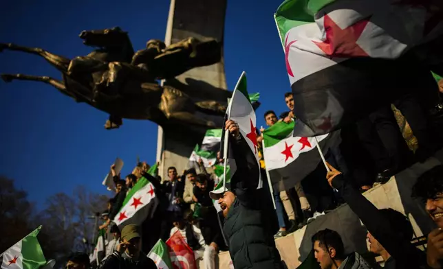 People gather to celebrate the Syrian government fall in Istanbul, Turkey, Sunday, Dec. 8, 2024. (AP Photo/Emrah Gurel)