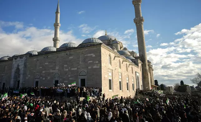 People gather to celebrate the Syrian government fall at Faith mosque in Istanbul, Turkey, Sunday, Dec. 8, 2024. (AP Photo/Emrah Gurel)