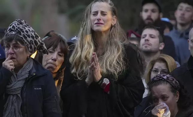 Relatives and friends of 1st Sgt. Hillel Diener, who was killed in combat in the Gaza Strip, mourn during his funeral at the Mount Herzl military cemetery in Jerusalem, Israel, Tuesday, Dec. 24, 2024. (AP Photo/Ohad Zwigenberg)