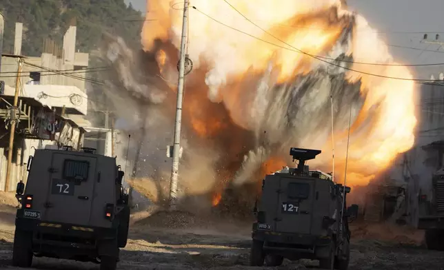 An explosive devise planted by Palestinian militants explodes after being detonated by Israeli soldiers during a military raid in the Nur Shams refugee camp near the West Bank city of Tulkarem, Tuesday, Dec. 24, 2024. (AP Photo/Majdi Mohammed)