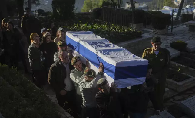 Israeli soldiers and relatives carry the flag-draped casket of 1st Sgt. Hillel Diener, who was killed in combat in the Gaza Strip, during his funeral at the Mount Herzl military cemetery in Jerusalem, Israel, Tuesday, Dec. 24, 2024. (AP Photo/Ohad Zwigenberg)