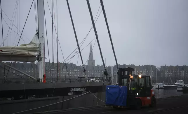 A fenwick brings a pallet to be loaded on the sailboat 'Grain de Sail II' at the port of Saint Malo, western France, Nov. 8, 2024. (AP Photo/Thibault Camus)