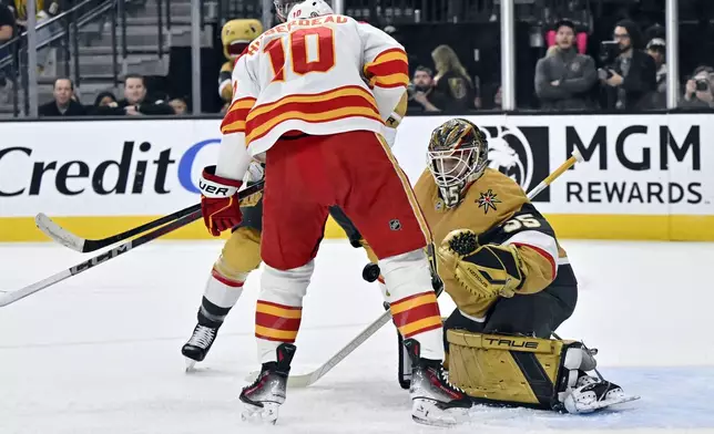 Calgary Flames center Jonathan Huberdeau (10) shoots against Vegas Golden Knights goaltender Ilya Samsonov (35) during the first period of an NHL hockey game Sunday, Dec. 29, 2024, in Las Vegas. (AP Photo/David Becker)