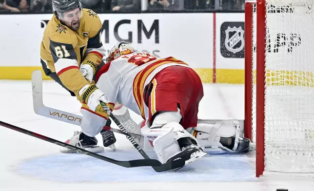 Vegas Golden Knights right wing Mark Stone (61) shoots against Calgary Flames goaltender Dan Vladar (80) during the second period of an NHL hockey game Sunday, Dec. 29, 2024, in Las Vegas. (AP Photo/David Becker)