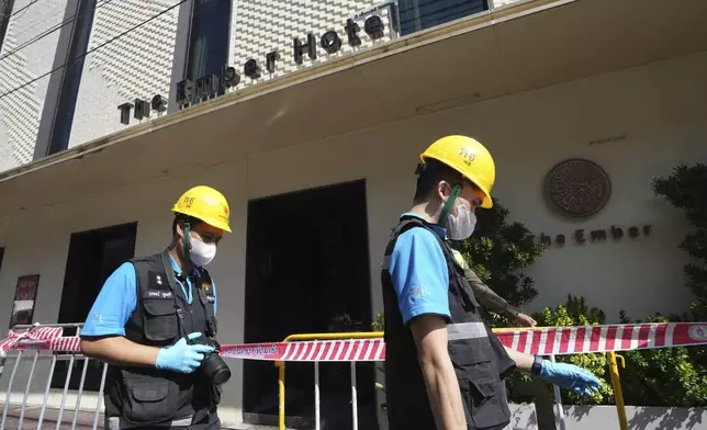 Police forensics team arrive at a hotel in Bangkok, Thailand, Monday, Dec. 30, 2024 after a fire. (AP Photo/Sakchai Lalit)