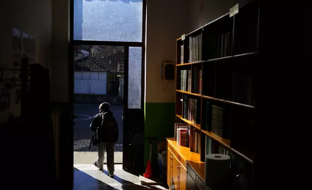 Student Panagiotis leaves the primary school in Fourna village, central Greece, Monday, Nov. 25, 2024. (AP Photo/Thanassis Stavrakis)