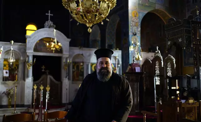 Rev. Constantine Dousikos poses at the Orthodox church of Transfiguration of Christ in Fourna village, central Greece, Monday, Nov. 25, 2024. (AP Photo/Thanassis Stavrakis)
