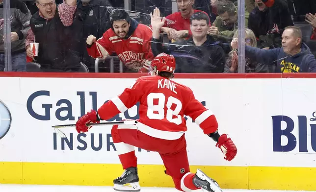 Detroit Red Wings right wing Patrick Kane (88) and fans celebrate his goal against the Philadelphia Flyers during the third period of an NHL hockey game Wednesday, Dec. 18, 2024, in Detroit. (AP Photo/Duane Burleson)