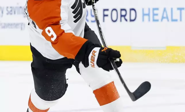 Philadelphia Flyers defenseman Jamie Drysdale (9) takes a shot on goal against the Detroit Red Wings during the second period of an NHL hockey game Wednesday, Dec. 18, 2024, in Detroit. (AP Photo/Duane Burleson)