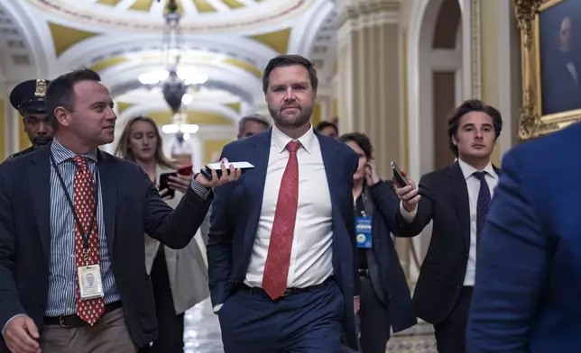 Sen. JD Vance, R-Ohio, the vice president-elect, leaves the Senate chamber as lawmakers work on an interim spending bill to avoid a shutdown of federal agencies, at the Capitol in Washington, Wednesday, Dec. 18, 2024. (AP Photo/J. Scott Applewhite)