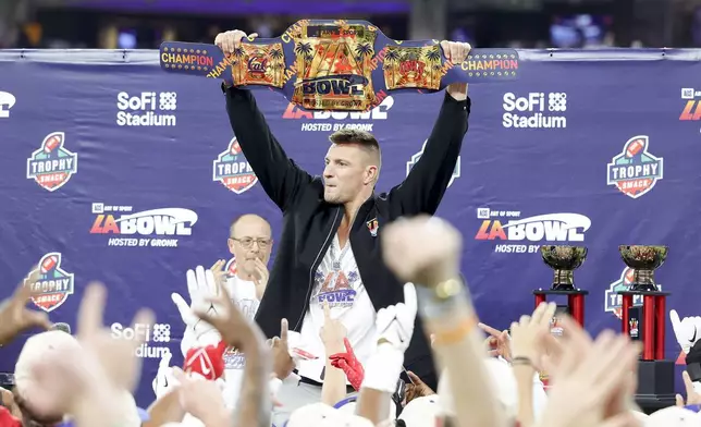 Former NFL tight end Rob Gronkowski holds up the LA Bowl belt after UNLV's victory over California during the LA Bowl NCAA college football game Wednesday, Dec. 18, 2024, in Inglewood, Calif. (AP Photo/Ryan Sun)