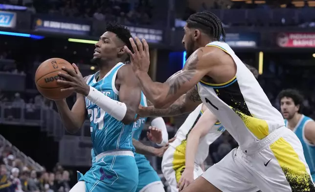 Charlotte Hornets' Brandon Miller (24) goes to the basket against Indiana Pacers' Obi Toppin (1) during the first half of an NBA basketball game, Sunday, Dec. 8, 2024, in Indianapolis. (AP Photo/Darron Cummings)