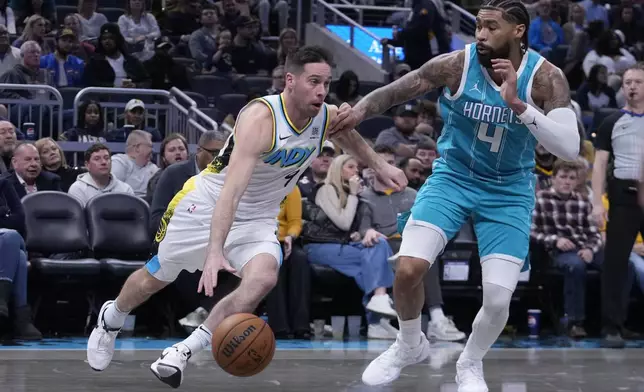 Indiana Pacers' T.J. McConnell goes to the basket against Charlotte Hornets' Nick Richards (4) during the second half of an NBA basketball game, Sunday, Dec. 8, 2024, in Indianapolis. (AP Photo/Darron Cummings)