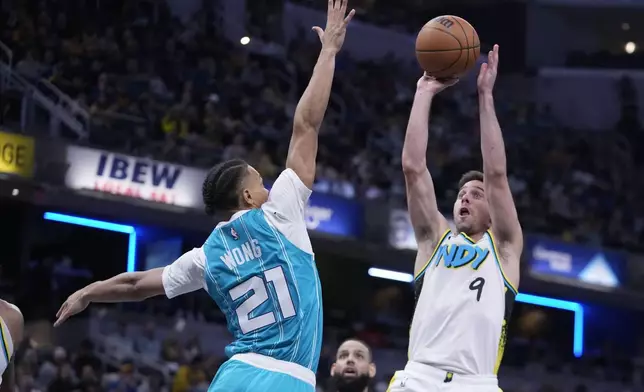 Indiana Pacers' T.J. McConnell (9) shoots over Charlotte Hornets' Isaiah Wong (21) during the second half of an NBA basketball game, Sunday, Dec. 8, 2024, in Indianapolis. (AP Photo/Darron Cummings)